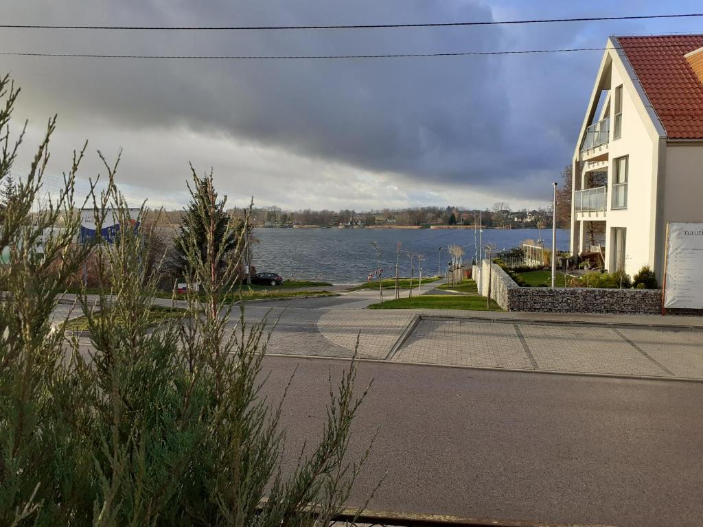 a view of a river with a house and a building at Apartament in Rydzewo