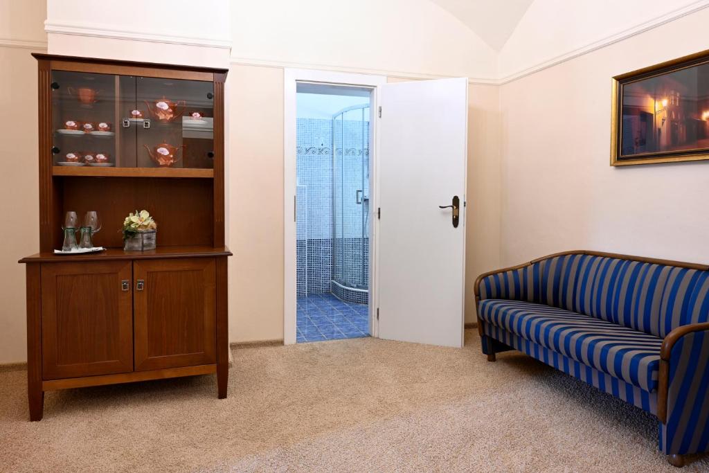 a living room with a couch and a sliding glass door at Hotel Bouček in Kroměříž
