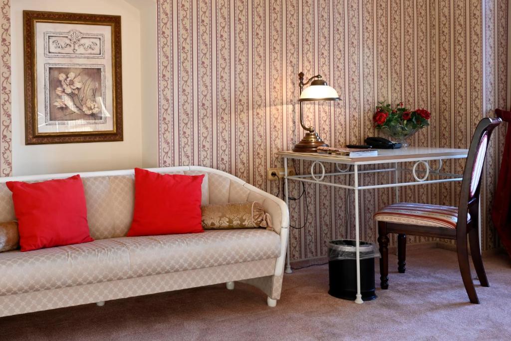 a living room with a couch and a table at Hotel Bouček in Kroměříž