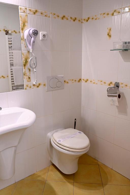 a bathroom with a toilet and a sink at Hotel Bouček in Kroměříž