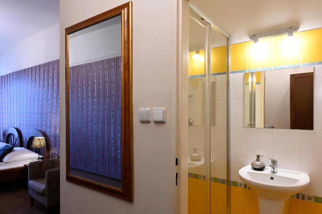 a bathroom with a sink and a mirror at Hotel Bouček in Kroměříž