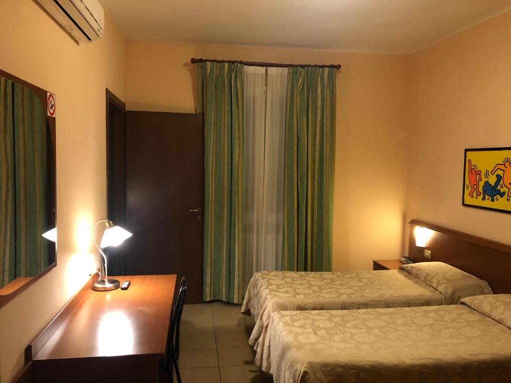 Postel nebo postele na pokoji v ubytování Hotel Paradiso