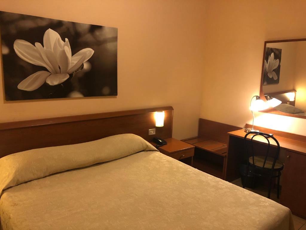 Postel nebo postele na pokoji v ubytování Hotel Paradiso