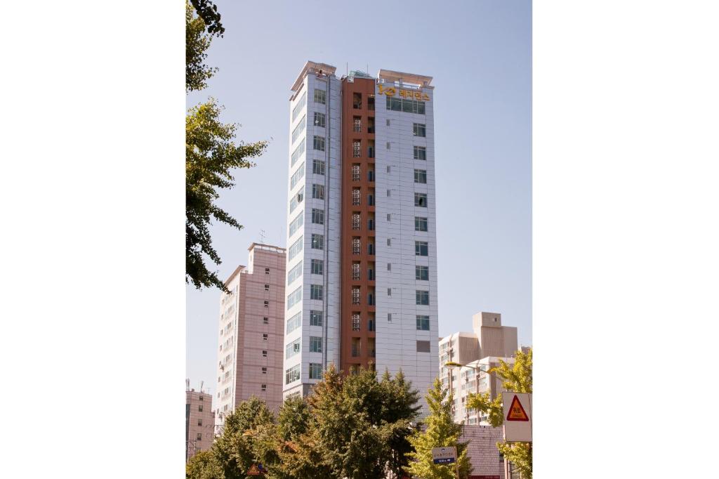 a tall white building in a city at YD Residence in Seoul