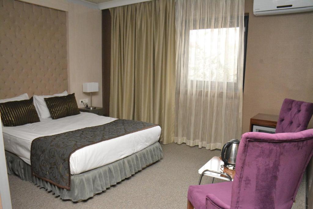 Postel nebo postele na pokoji v ubytování koza millenyum hotel&spa