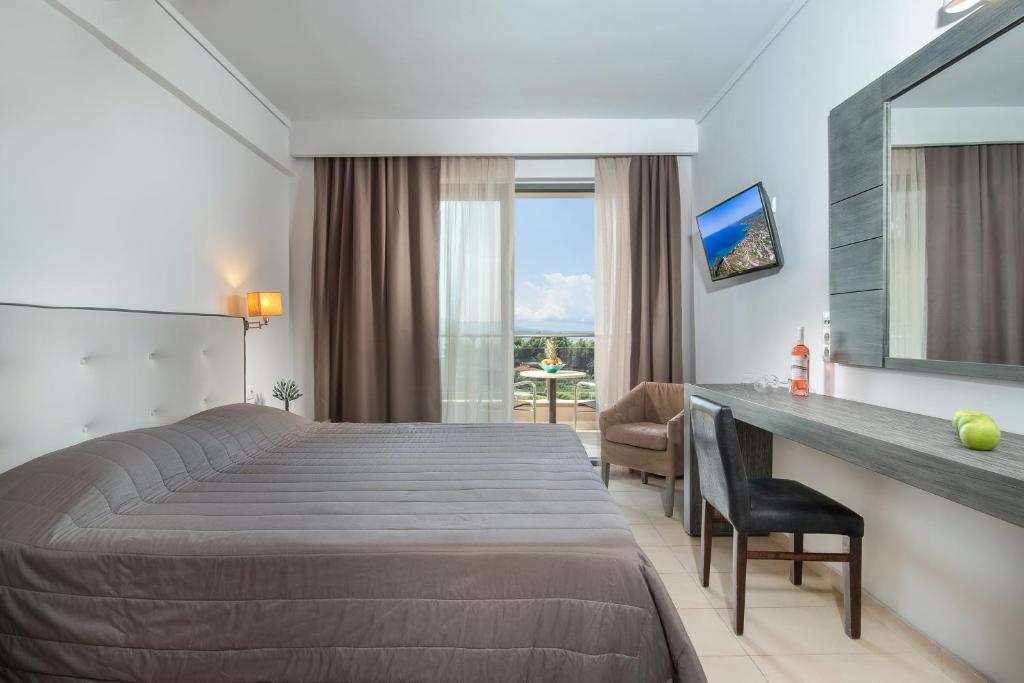 a hotel room with a bed and a desk at Lagomandra Hotel and Spa in Lagomandra