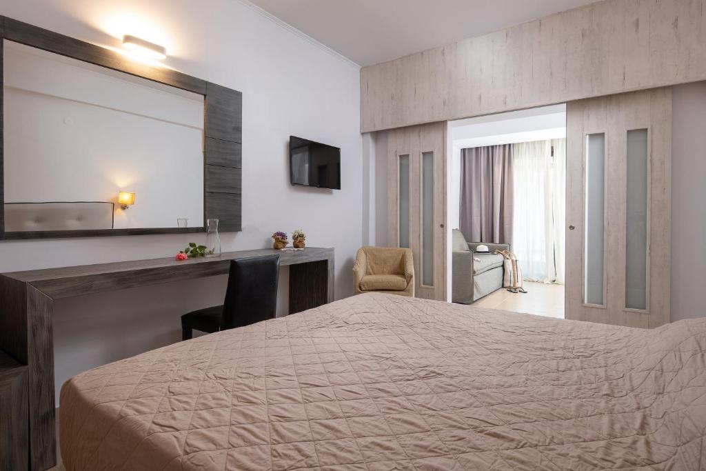 a hotel room with a bed and a mirror at Lagomandra Hotel and Spa in Lagomandra
