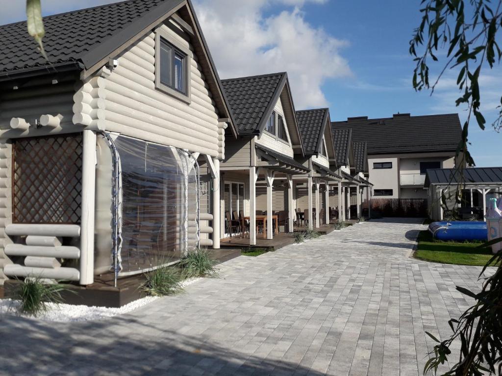 a row of houses with a driveway at Holiday Homes 777 in Karwia