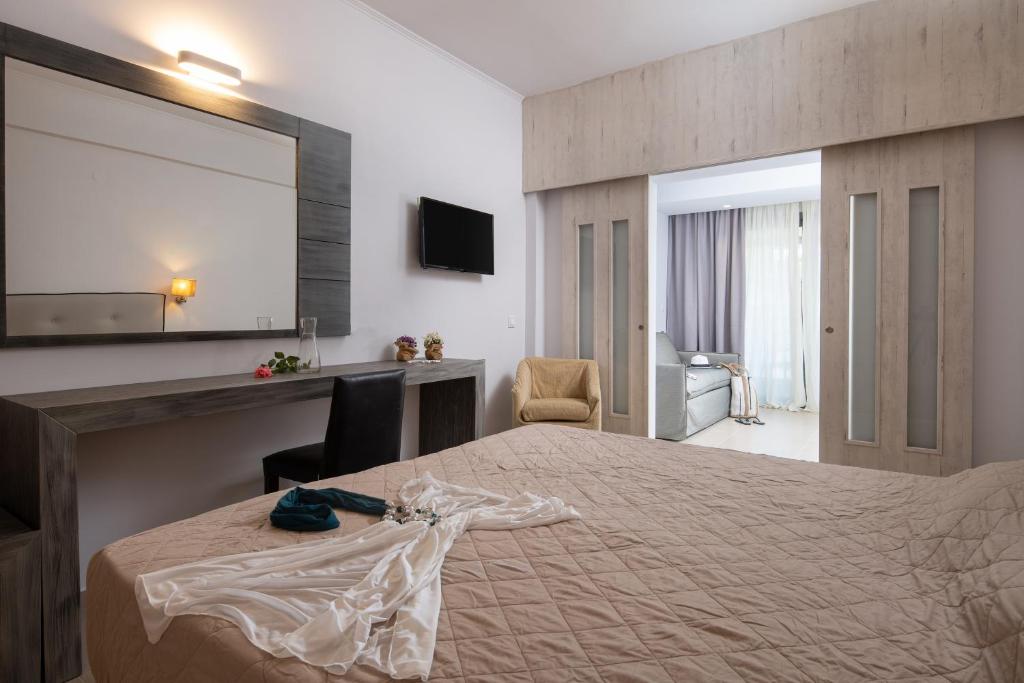 a hotel room with a bed and a mirror at Lagomandra Hotel and Spa in Lagomandra