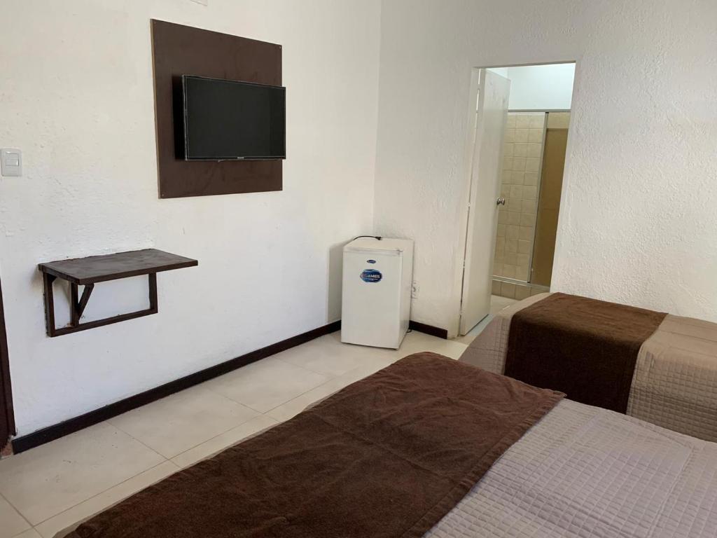 Postel nebo postele na pokoji v ubytování Hotel American