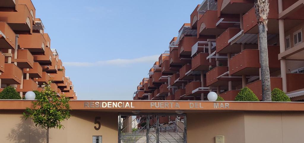 een gebouw met een bord met de tekst derza pitchel del mar bij Apartamento nuevo playa de Canet de Berenguer WIFI in Canet de Berenguer