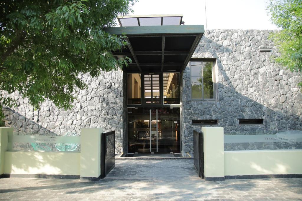 a stone building with a glass entry door at Ranqueles in Villa Carlos Paz