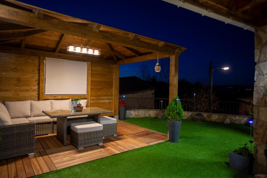 a patio with a couch and a table and a screen at Casa dos arcos in Sober