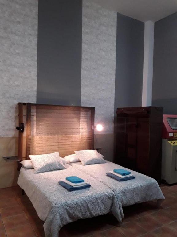 a bedroom with a large bed with two towels on it at INDUSTRIAL LOFT in Guargacho