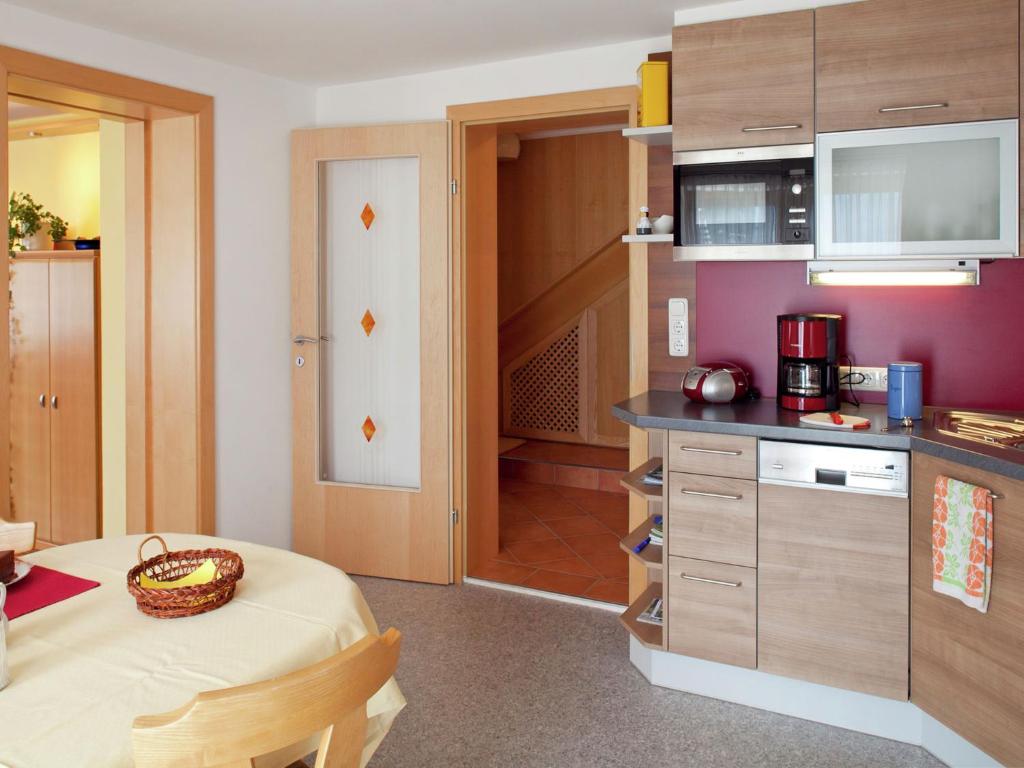 a small kitchen with a table in a room at Apartment near Zell am See Kaprun in Niedernsill
