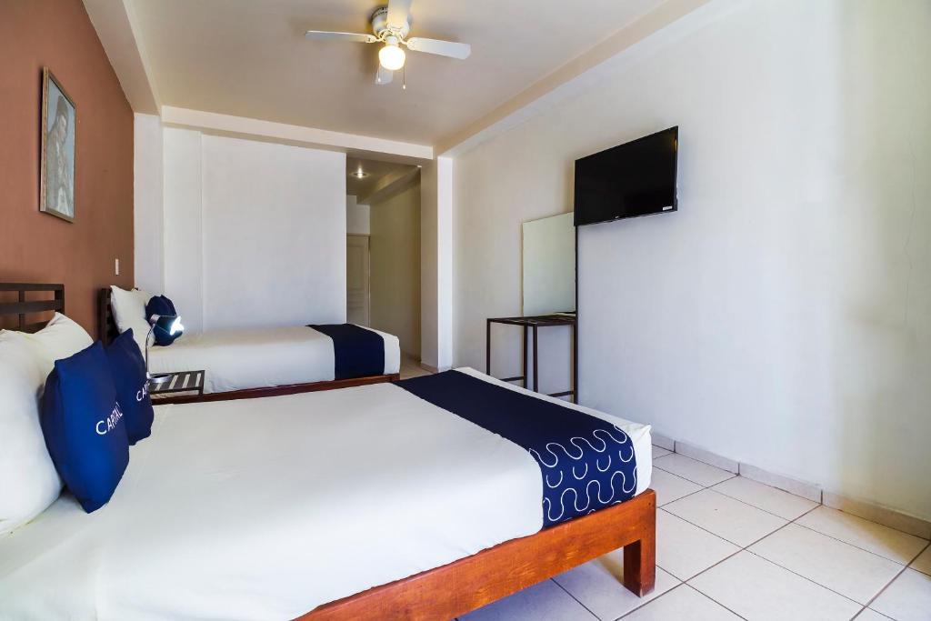 Postel nebo postele na pokoji v ubytování Hotel Plaza Galindo