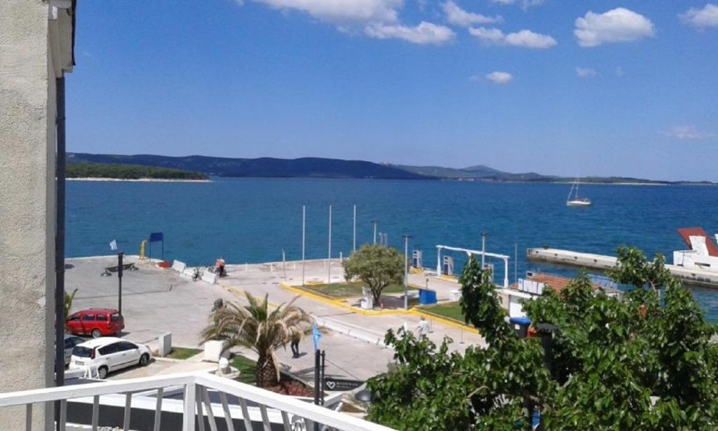 a view of a large body of water from a balcony at Apartments Drago - apartments in the center in Biograd na Moru