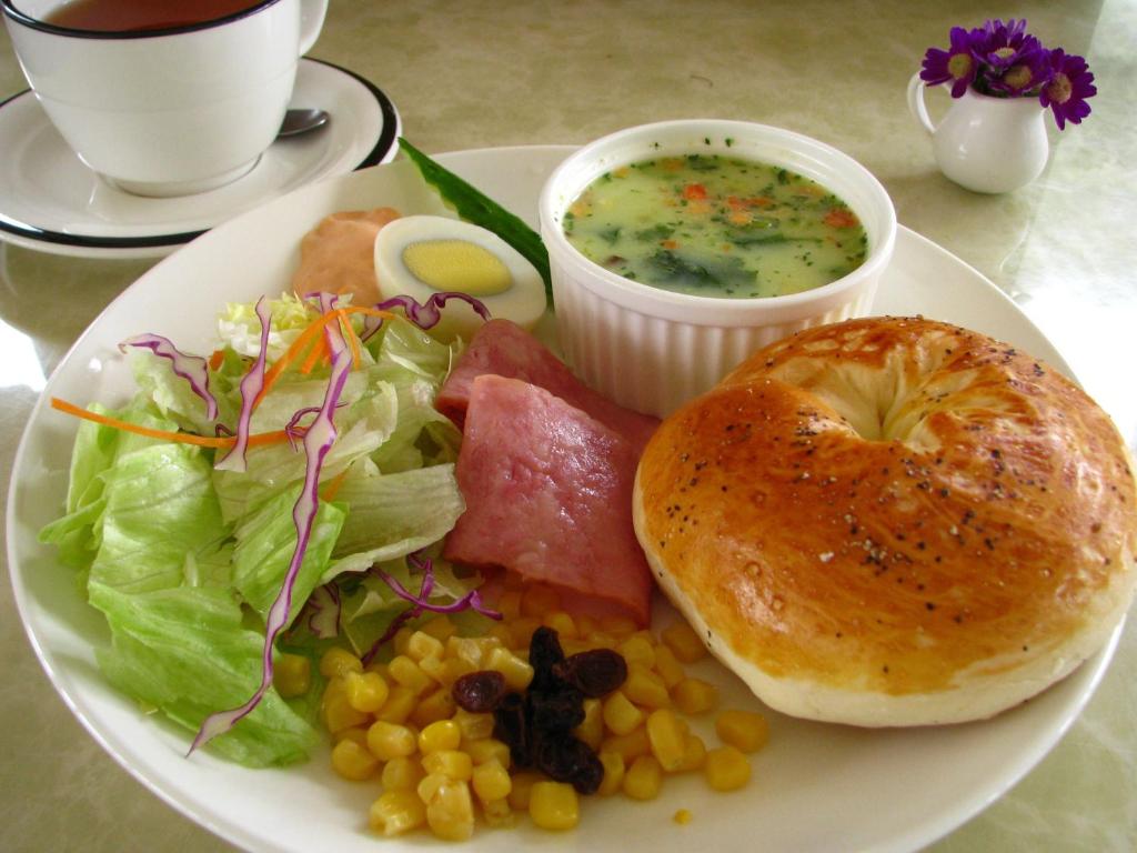 a plate of food with soup and a bagel and salad at Ying Shih Guest House in Datong