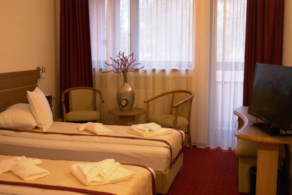 Postel nebo postele na pokoji v ubytování Hotel Carpați