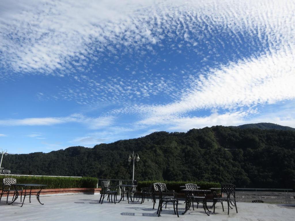 a group of tables and chairs under a cloudy sky at Ying Shih Guest House in Datong