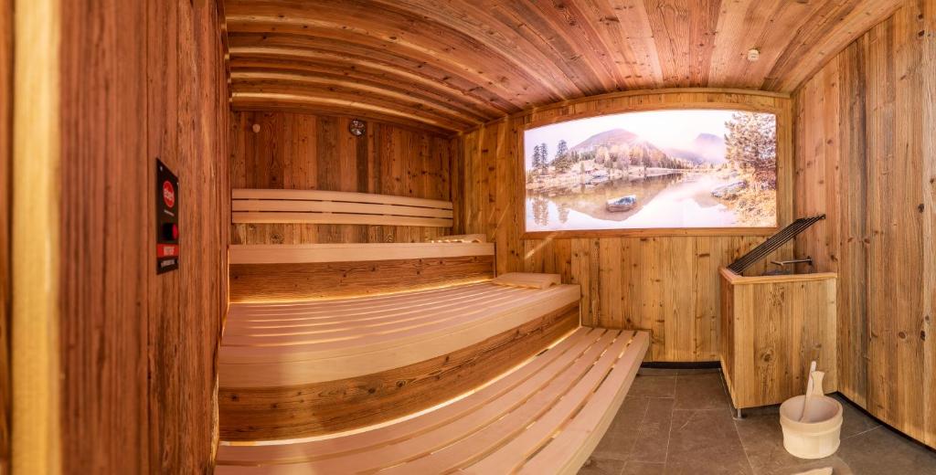 a sauna with wooden walls and a large window at Scheulinghof in Mayrhofen