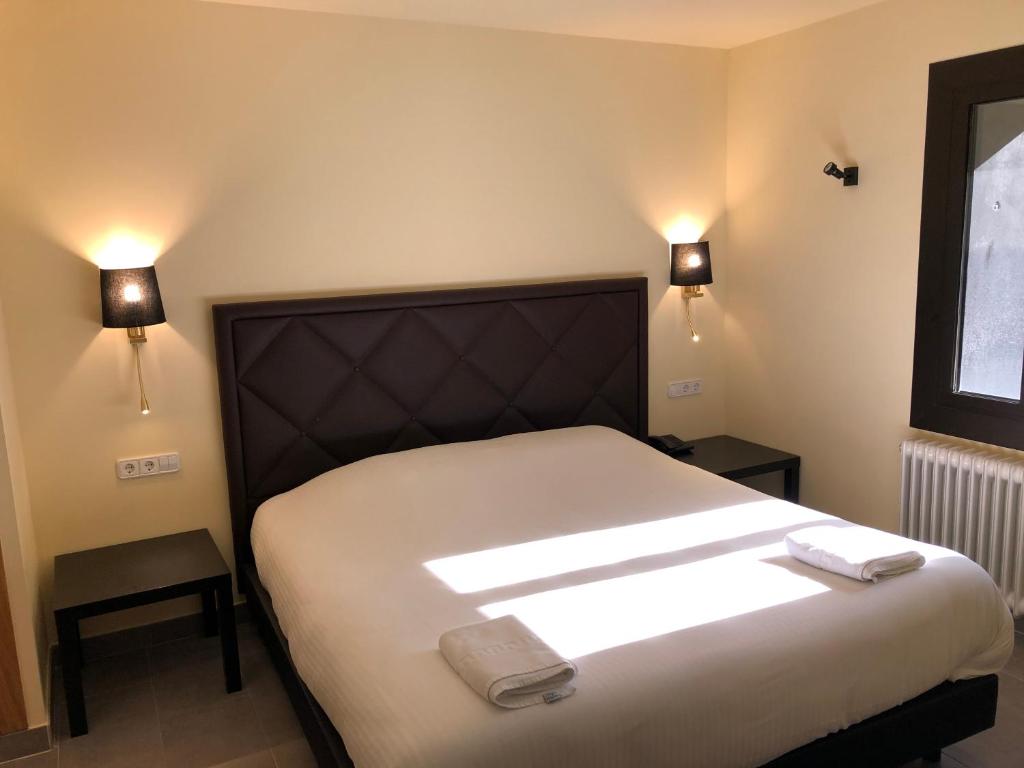 Postel nebo postele na pokoji v ubytování Hotel Guineu