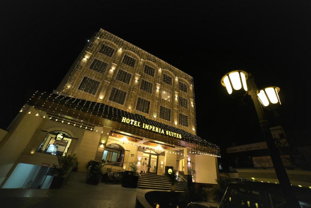 a large building with lights on it at night at Hotel Imperia Suites in Jalandhar