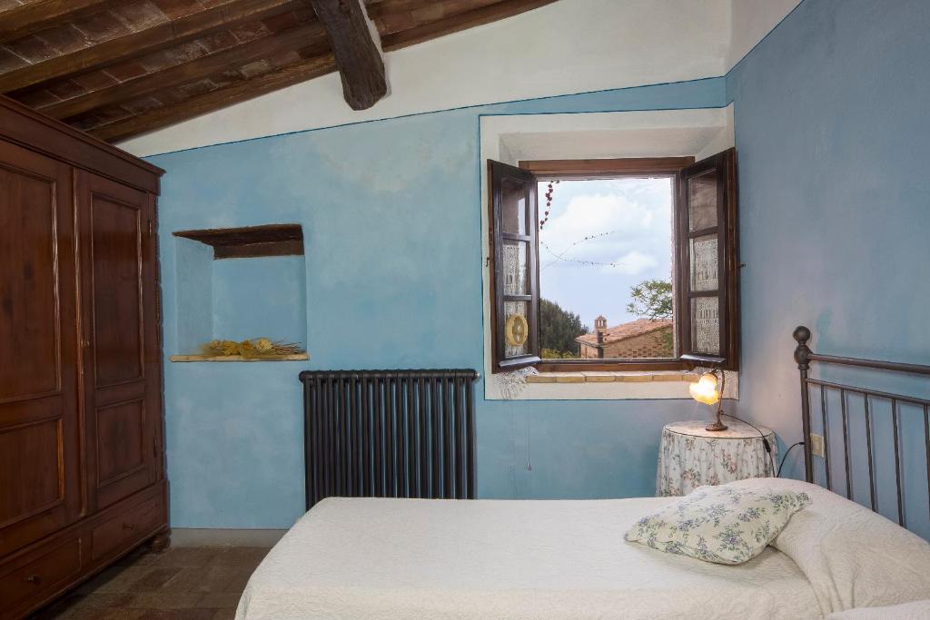 Postel nebo postele na pokoji v ubytování Podere La Casetta - Casa di Campagna