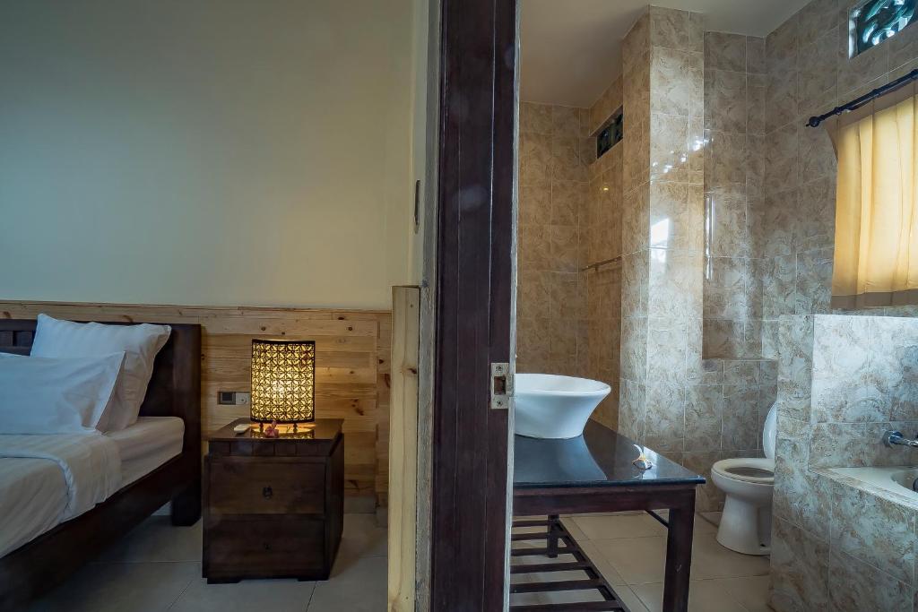 Postel nebo postele na pokoji v ubytování Iman Homestay Ubud