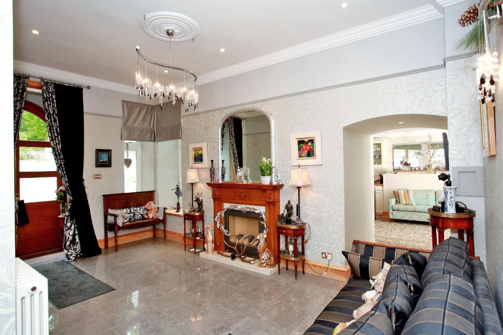 a living room with a couch and a fireplace at Luxury Scottish Apartment in Aberdeen