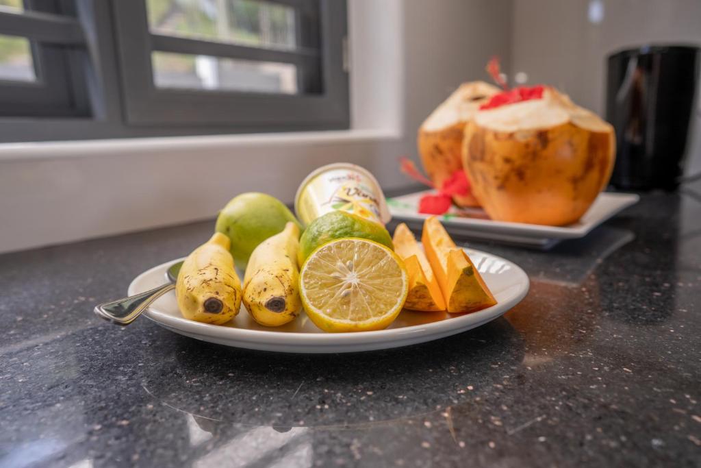 a plate of fruit on top of a counter at Kolibri Holiday Apartments in Victoria