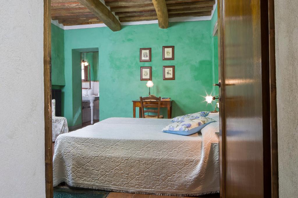 Postel nebo postele na pokoji v ubytování Podere La Casetta - Casa di Campagna