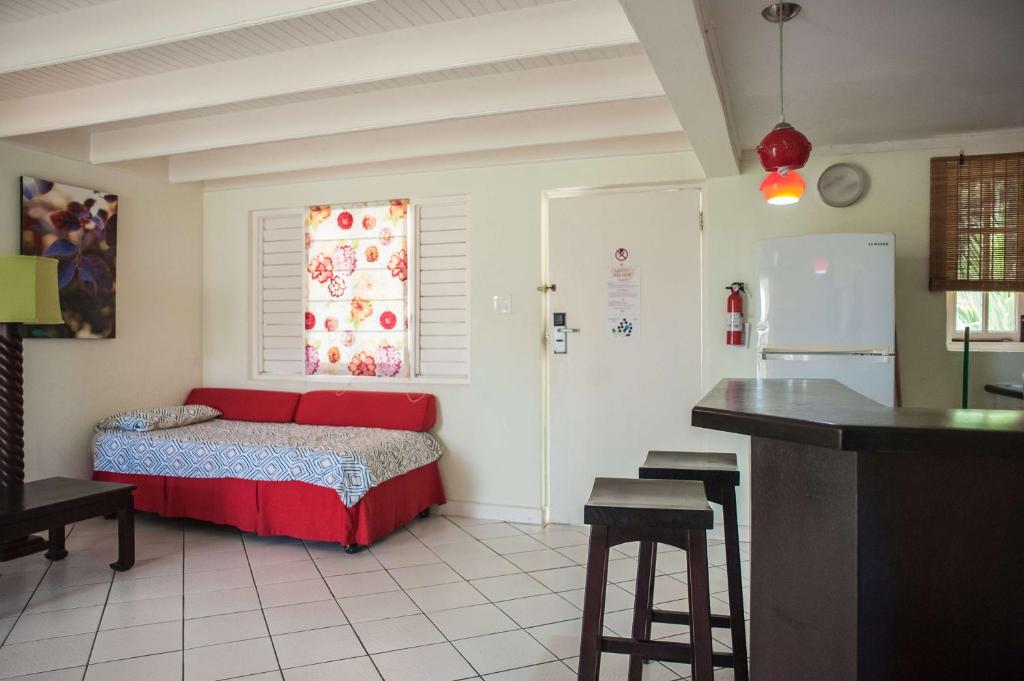 a bedroom with a bed and a kitchen with a counter at Mystic Ridge Resort in Ocho Rios