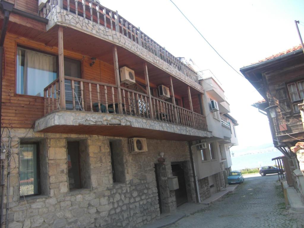 a building with a balcony on the side of it at Guest House Antoaneta in Nesebar