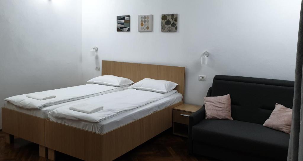 um quarto com uma cama e uma cadeira em Madalina em Brasov