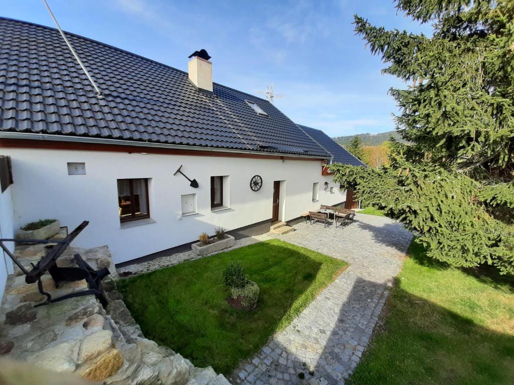 an aerial view of a white house with a yard at Chalupa Chlum Míša in Volary