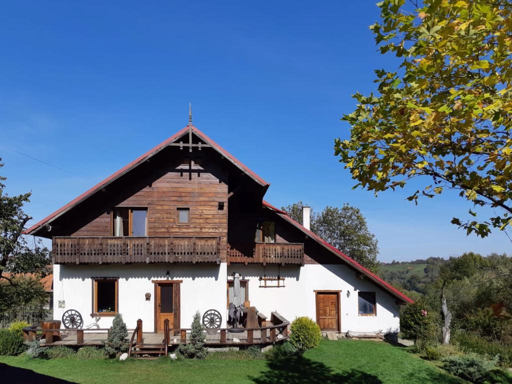 a large white house with a gambrel roof at Cabana Festung in Bran