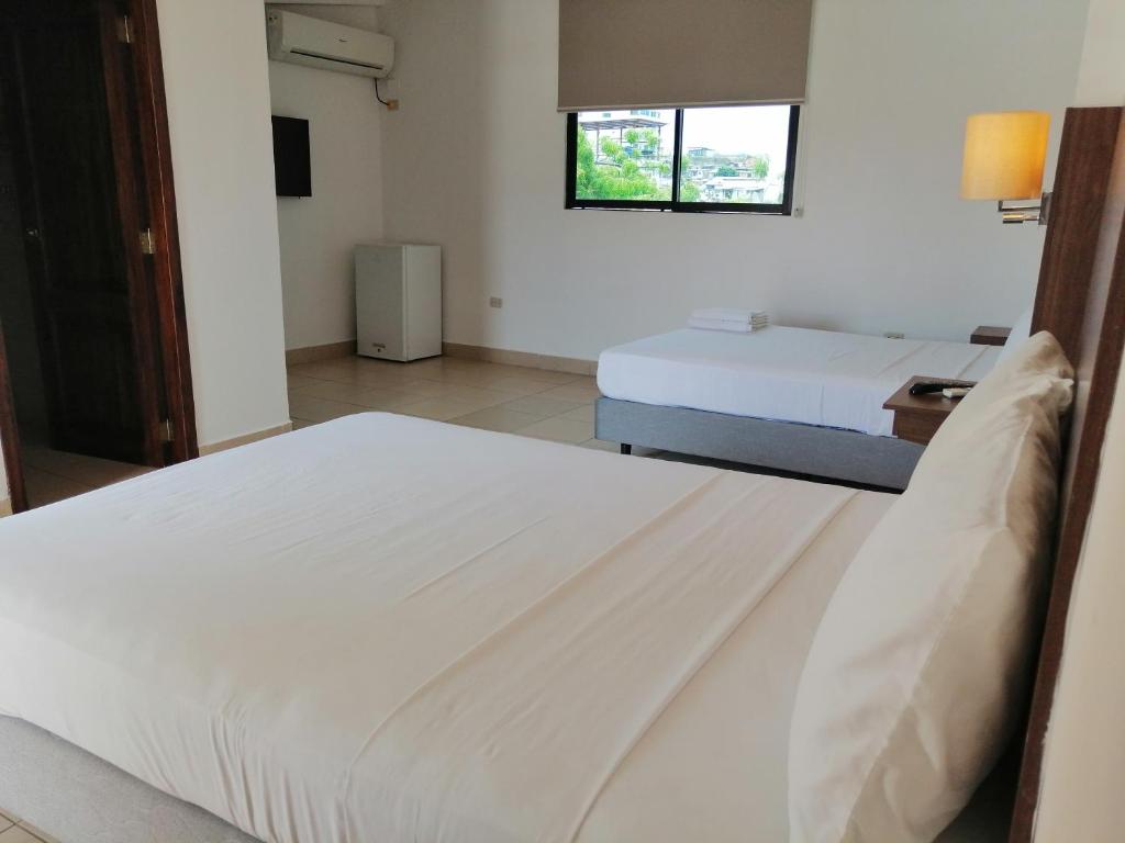 Postel nebo postele na pokoji v ubytování Buenavista Place Hotel