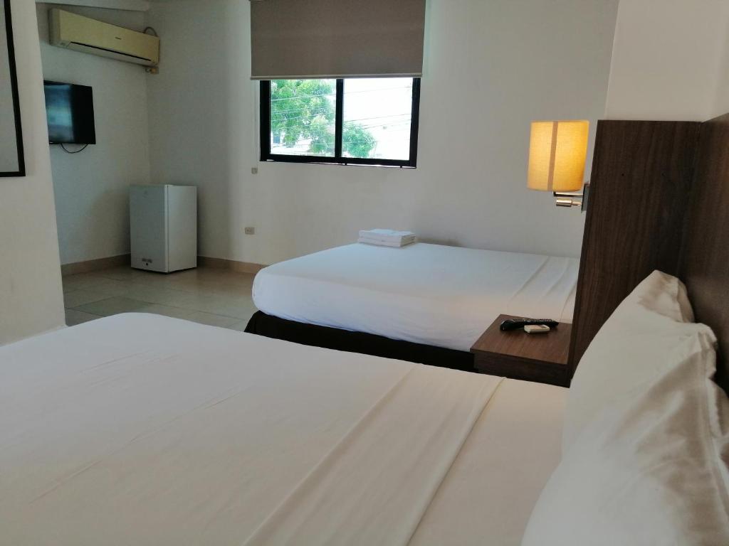 Postel nebo postele na pokoji v ubytování Buenavista Place Hotel