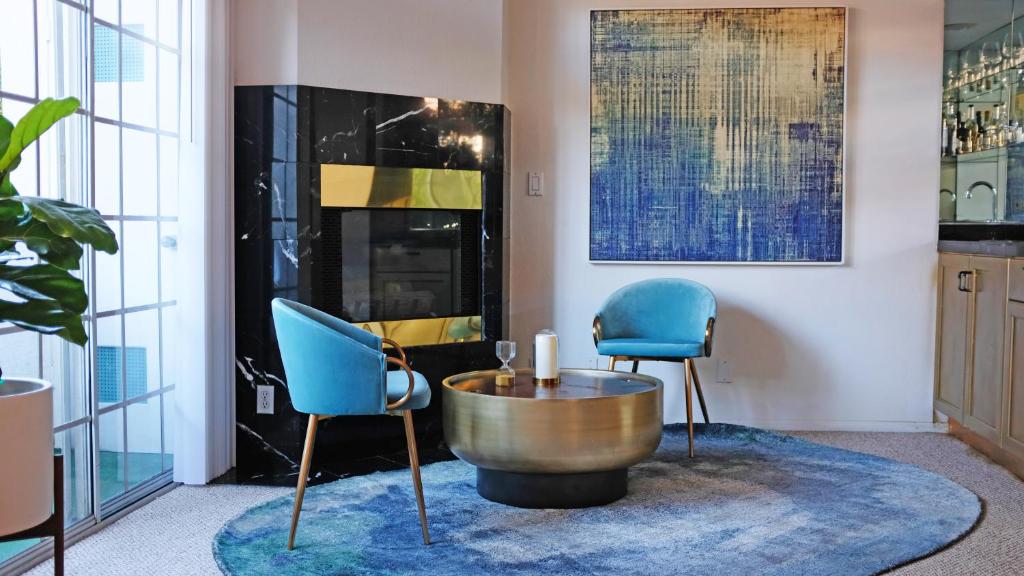 a living room with two blue chairs and a table at The Clouds in Los Angeles