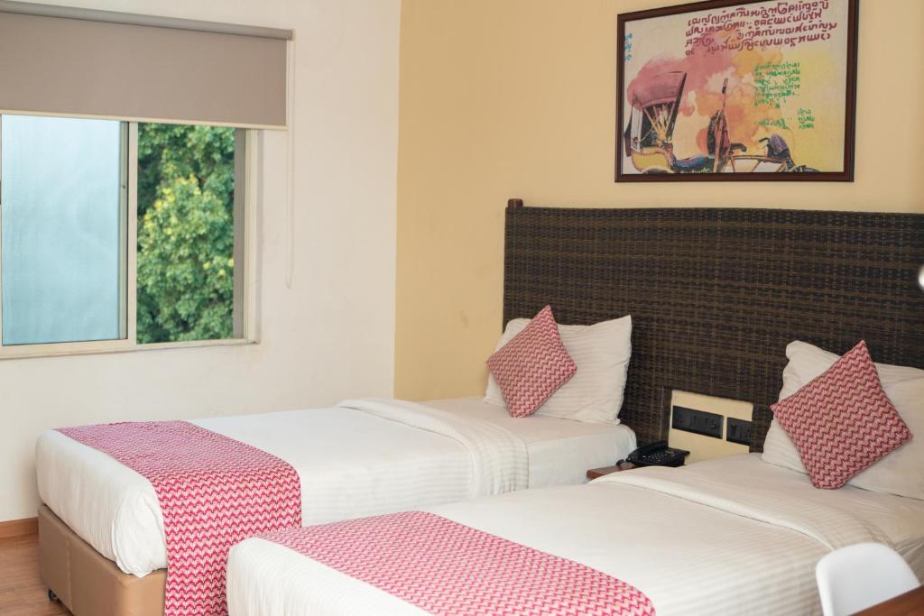 Postel nebo postele na pokoji v ubytování Hotel Beebiz Guindy