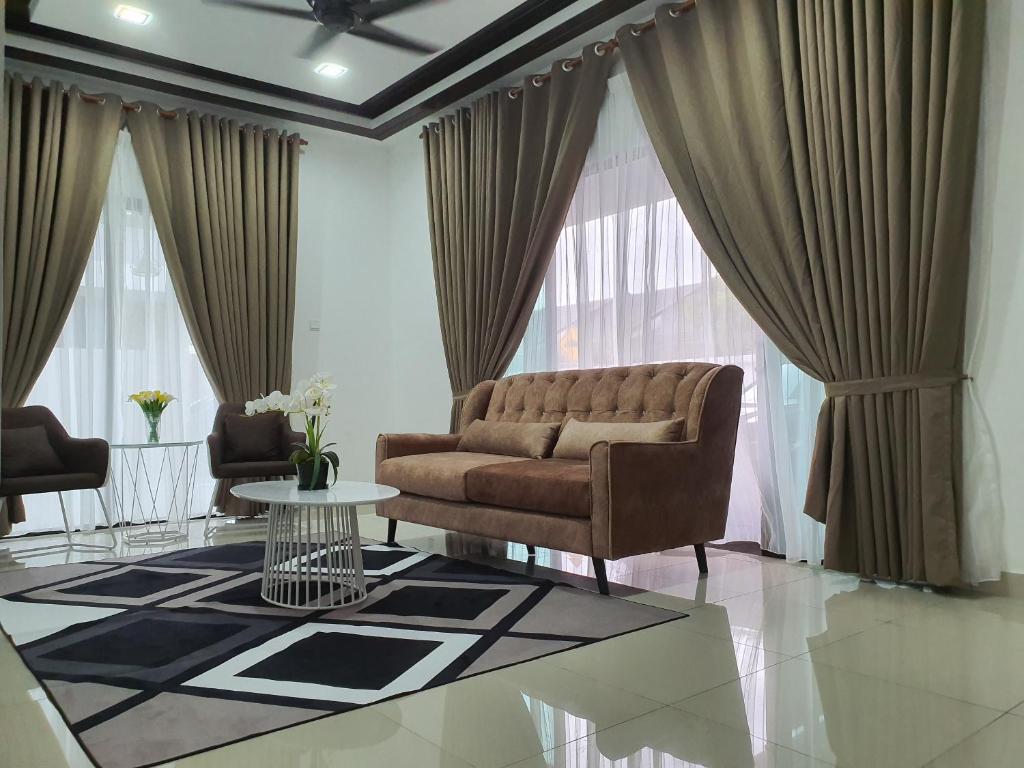 a living room with a couch and a table at Muslim Homestay D'Bertam, Kepala Batas, Penang in Kepala Batas