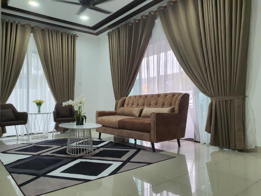 a living room with a couch and a table at Homestay D'Bertam, Kepala Batas, Penang, Muslim Saja in Kepala Batas