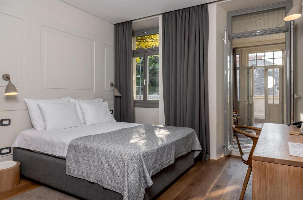 Postel nebo postele na pokoji v ubytování Hotel Peteani