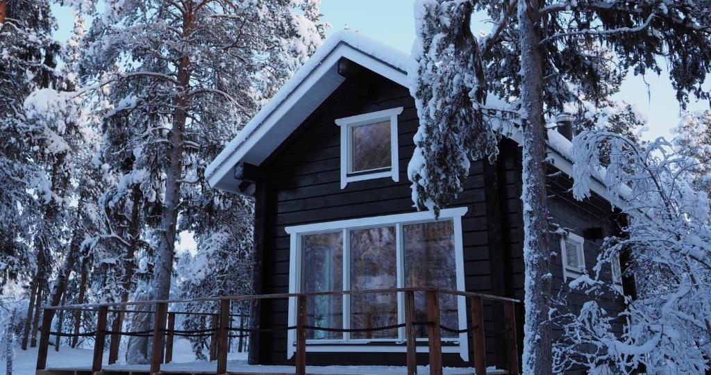 a cabin in the woods covered in snow at LapinTintti Eco-Cabin in Inari in Inari