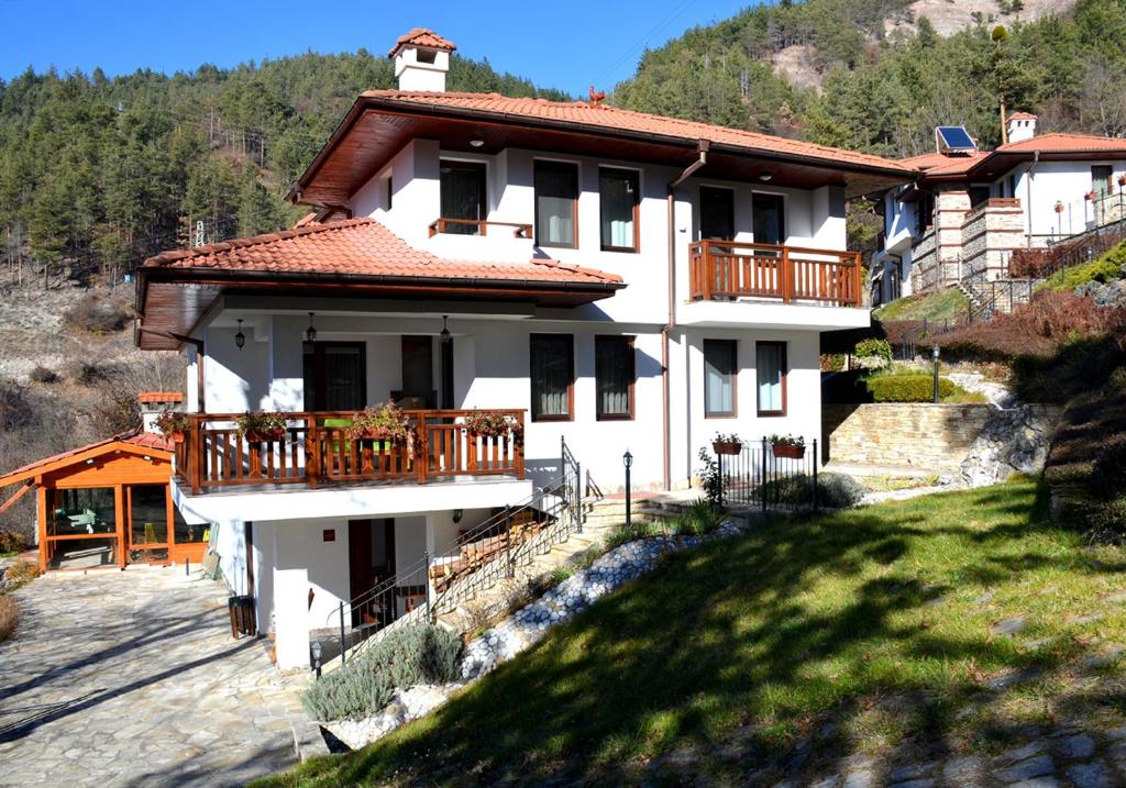 代溫的住宿－Къщи за гости "КАРАТА" 2，山丘上带阳台的白色房屋