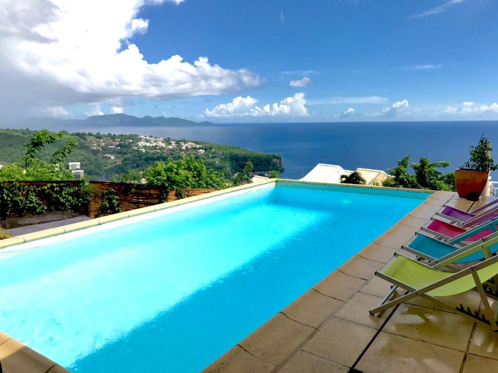 a swimming pool with a view of the ocean at Villa Zenith in Case-Pilote