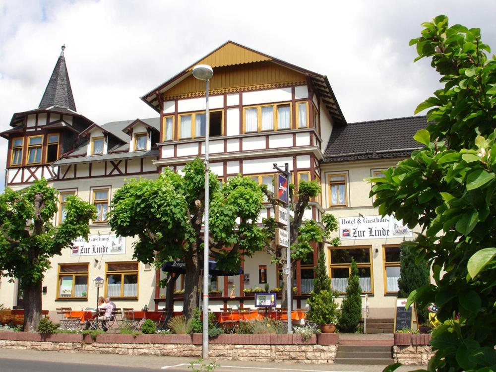 a large building with a pointed roof at Gasthaus & Hotel Zur Linde in Friedrichroda