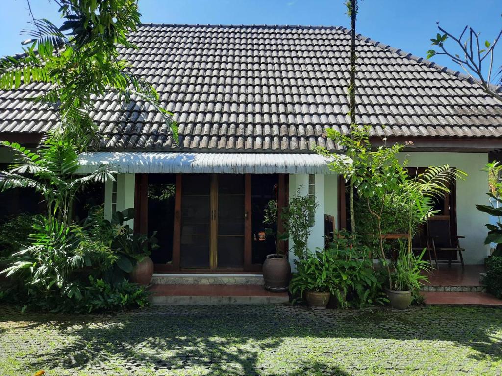 a house with plants in front of it at Bungalow Apartment Kamala in Phuket