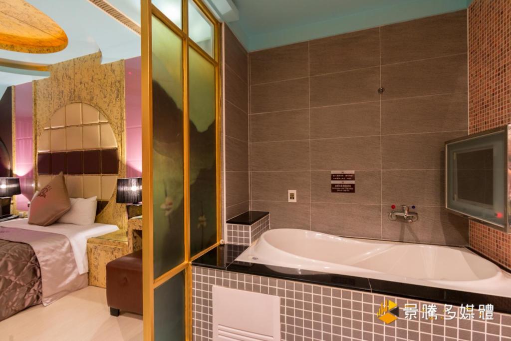 Postel nebo postele na pokoji v ubytování Zheng Yi Hotel & Motel I